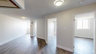 Located at 295 Dufferin St, Suite 509 in Toronto's vibrant King West neighbourhood, this 2-bedroom, 1-bathroom unit offers a practical and modern living space across a single floor. The interior is finished with light wood-look laminate flooring throughout the main living areas and bedrooms, complemented by crisp white walls and clean baseboards that give the unit a fresh, contemporary feel.

The kitchen is efficiently designed with white cabinetry, dark tile backsplash, polished dark tile flooring, and a full suite of stainless steel appliances including a range, over-the-range microwave, and dishwasher — making it both functional and stylish. The bathroom features a modern vanity with wood-toned cabinetry and white countertop, subway tile walls, dark slate-style floor tiles, and a bathtub with tiled surround, creating a clean and classic aesthetic.

Both bedrooms are bright and offer a comfortable footprint, with windows providing natural light and urban views of the surrounding Toronto skyline. The primary bedroom offers a cozy yet practical space, while the second bedroom is similarly well-proportioned. The neutral colour palette throughout the unit creates a versatile canvas well-suited for a variety of furnishing styles.
