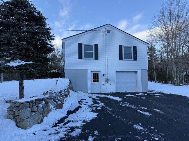 Side of house showing overhead door leading into basement - 17 Range Hill Rd