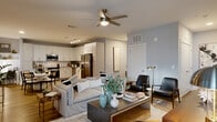 Located at 940 E Adams St in Jacksonville, FL, this thoughtfully designed two-bedroom, three-bathroom residence offers a cohesive blend of modern aesthetics and functional living. The open-concept kitchen and living area serves as the heart of the home, with the kitchen showcasing white flat-panel cabinetry, granite countertops, a classic subway tile backsplash, stainless steel appliances including a full-size refrigerator and built-in microwave, and light wood-look flooring that extends throughout the common areas. Track lighting overhead enhances the space's bright, contemporary character. The adjoining living room is generously proportioned, featuring a ceiling fan, large windows that invite natural light, and a neutral gray palette that creates a calm, inviting ambiance. Both bedrooms are carpeted and well-lit, each with ceiling fans, ample natural light from multiple windows, and access to dedicated closet space — including a walk-in closet with wire shelving. The three bathrooms are finished with wood-look tile flooring, glass-enclosed walk-in showers with large-format tile surrounds, white vanities, and refined fixtures. Each room reflects consistent attention to detail, making this a polished and comfortable residence in the heart of Jacksonville.