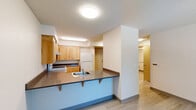 Located at 5335 SW Murray Blvd in Beaverton, Oregon, this one-bedroom, one-bathroom residence offers a thoughtfully arranged single-level layout designed for comfortable everyday living. Light wood-style flooring flows throughout the space, complemented by neutral wall tones and textured ceilings that lend a clean, consistent aesthetic.

The kitchen is a standout feature, equipped with warm-toned light wood cabinetry offering generous upper and lower storage, dark laminate countertops, a stainless steel sink, an electric range, and a full-size refrigerator. A peninsula with bar-height seating and a second sink adds both functionality and a natural separation between the kitchen and the adjacent living area, making the space feel open and connected.

The living area benefits from a window that allows natural light to filter in, creating a bright and welcoming atmosphere. The bedroom is a comfortable size, featuring a sliding-door closet for convenient storage, with an additional closet available elsewhere in the unit.

The bathroom includes a wood-toned vanity with dark countertop and drawer storage, maintaining the cohesive design language found throughout the residence. Practical and well-appointed, this Beaverton home provides an efficient and inviting living environment.