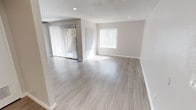 This single-floor residence offers a clean, contemporary aesthetic with consistent light-toned luxury vinyl plank flooring and neutral warm-gray walls carried throughout the space. The open living and dining area is generously proportioned, filled with abundant natural light streaming through large windows and a sliding glass door fitted with vertical blinds. Recessed lighting and a textured ceiling complete the bright, airy atmosphere of this central gathering space.

The galley-style kitchen is efficiently designed with white shaker cabinetry, granite-look countertops, a stainless steel sink, and black stainless appliances including a gas range, dishwasher, and refrigerator. Recessed lighting and ample cabinet storage make the kitchen both practical and visually clean.

Multiple bedrooms are well-proportioned, each featuring ceiling fans, vertical-blind windows that invite natural light, and closet access. The rooms share a consistent, neutral palette that makes them versatile and inviting.

The bathroom includes a tub-shower combination with a curved rod, brushed nickel fixtures, white cabinetry, and a granite-topped vanity with a mirrored medicine cabinet. Clean white trim and baseboards tie together all rooms cohesively, creating a move-in-ready space with a polished, updated feel throughout.