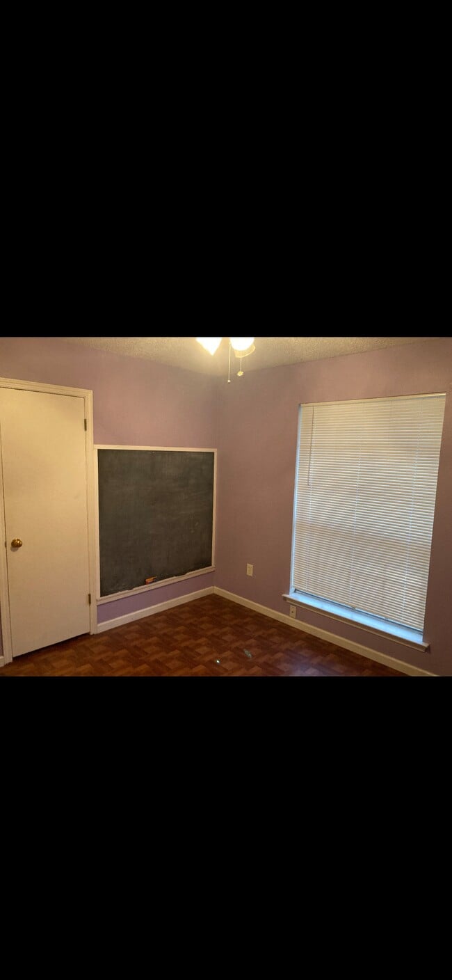 Fun chalkboard wall in guest bedroom. - 1541 Live Oak St