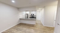 This contemporary apartment in Charlotte, NC offers 1070 square feet of efficiently designed living space. The single-story layout includes three bedrooms, two full bathrooms, and a combined kitchen and living area. The primary bedroom, measuring 200 square feet, provides a spacious retreat.

Throughout the apartment, wood-look flooring creates a warm, cohesive aesthetic. The kitchen showcases modern amenities with stainless steel appliances, granite countertops, and sleek white cabinetry. A dedicated laundry room with full-sized washer and dryer adds convenience.

Each bedroom features ceiling fans and large windows that invite natural light, while mini-split air conditioning units ensure year-round comfort. The bathrooms are outfitted with granite vanities and shower/tub combinations.

Storage solutions abound, with a walk-in closet in the primary bedroom and additional closet space throughout. The open floor plan allows for flexible living arrangements, ideal for both relaxation and entertainment.

Located at 1931 Lamm Dr in Charlotte, this apartment combines modern design with practical amenities, offering a comfortable and stylish living environment.