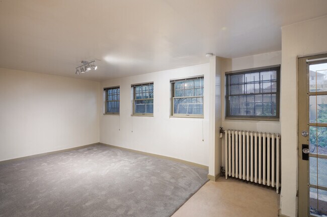 Carpeted living room with four southern exposure windows. - 1029 Summit Ave E