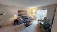 Located at 816 Kinwest Pkwy in Irving, Texas, this single-story residence offers a well-organized layout across several distinct living spaces. The living room serves as the heart of the home, featuring wall-to-wall carpet, a textured ceiling, and a sliding glass door fitted with vertical blinds that provides access to an outdoor patio and brings in natural light. The open, comfortable atmosphere is well-suited for everyday living and entertaining.

The kitchen is equipped with dark espresso cabinetry, granite-style countertops, and a black electric range. A window above the counter area allows natural light to filter in, enhancing the functional workspace. Adjacent to the kitchen, the dining area accommodates a four-person table beneath a ceiling fan with light fixture, completing a practical layout ideal for daily meals.

The bedroom is carpeted and includes a reach-in closet, a natural light window with curtains, and ample wall space. The bathroom features a full tub-shower combination with tile surround, a dark-vanity with granite-style countertop, wood-look flooring, and framed wall art, giving it a polished, cohesive finish throughout.