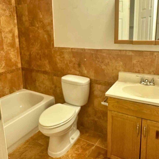 Floor to Ceiling Ceramic Tile Bathroom - 2448 Lakeview Ave