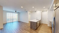 Located at 2058 East Apache Boulevard in Tempe, Arizona, this modern 2-bedroom, 1-bathroom residence offers a thoughtfully designed open-concept layout with consistent wood-look flooring throughout. The living and dining area flows seamlessly from the kitchen, filled with natural light from large sliding glass doors that lead to a private balcony. A ceiling fan adds comfort to the airy living space.

The kitchen is a standout feature, anchored by a large island with a white quartz countertop and an integrated sink. Wood-toned lower cabinetry pairs with white upper cabinets and a subway tile backsplash, complemented by a full suite of stainless steel appliances including a refrigerator, range, microwave, and dishwasher.

The generously sized primary bedroom offers ample space and connects to a walk-in closet with built-in shelving and hanging rods. A second walk-in closet provides additional storage. The full bathroom features a tub-shower combination with white tile surround, a quartz vanity, and direct access to one of the walk-in closets.

The second bedroom is bright and well-proportioned, featuring a window with outdoor views of the Tempe surroundings. Clean white walls and recessed lighting throughout lend the entire space a crisp, contemporary aesthetic.