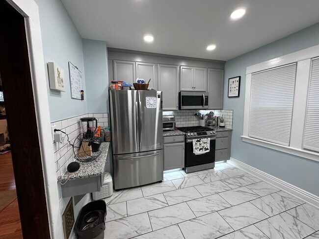 Kitchen with stainless refrigerator/freezer, microwave and stovestove - 1697 Hertel Ave