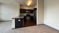 This contemporary apartment in Emsworth, Noblesville, offers 710 square feet of efficiently designed living space. The unit features two bedrooms, including a primary bedroom of 130 square feet, and one bathroom. The modern kitchen is a highlight, boasting dark wood cabinetry, granite countertops, and stainless steel appliances, including a refrigerator, stove, and over-the-range microwave. The kitchen's wood-look flooring adds warmth and durability.

The bathroom is well-appointed with a tub-shower combination, modern vanity, and matching wood-look flooring. A convenient in-unit laundry room comes equipped with a washer and dryer. Both bedrooms are carpeted for comfort and feature large windows that allow natural light to flood the spaces. The apartment's neutral color palette, with light walls and grey carpeting, creates a bright and airy atmosphere throughout.

Practical features include ample closet space and modern fixtures. The apartment's layout, as seen in the 3D floor plan, shows a thoughtful design that maximizes space and functionality. Located in the desirable 46060 zip code, this apartment combines modern amenities with a prime location in Noblesville, Indiana.