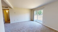 Located at 2350 Cowan Blvd in Fredericksburg, VA, this 2-bedroom, 3-bathroom unit offers a straightforward single-floor layout designed for comfortable, everyday living. The living room is a bright, open space finished with plush carpeting and anchored by a sliding glass door that opens to a private balcony, allowing natural light and outdoor views to flow in. A dedicated closet off the living area provides convenient storage. The kitchen features white cabinetry, dark speckled countertops, wood-style vinyl flooring, and standard appliances including a range and refrigerator, making efficient use of the available space. Both bedrooms are carpeted and filled with natural light from windows overlooking the outdoors. The generously sized primary bedroom includes a walk-in closet, while the second bedroom offers a comfortable and functional layout. Three bathrooms serve the unit, each featuring speckled countertop vanities, mirrors, and clean white fixtures. One bathroom includes a full tub-shower combination with tiled surround and wood-style flooring. Neutral tones and clean finishes are carried throughout the unit, creating a cohesive and move-in-ready atmosphere well-suited for a variety of lifestyles.