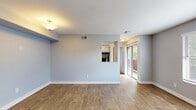 Located at 11710 Fuqua St in Houston, TX, this single-floor, 2-bedroom, 3-bathroom home offers a functional and well-appointed layout. The living room is bright and open, featuring warm wood-look flooring, soft neutral gray walls, and a pass-through window connecting to the kitchen — a practical design touch that enhances the sense of openness. Sliding glass doors lead to a private patio, bringing in natural light and easy outdoor access. The kitchen features white cabinetry and is efficiently arranged for everyday use. Both bedrooms are carpeted and equipped with ceiling fans, providing comfort year-round. Each bedroom benefits from natural light via windows with blinds, offering views of the surrounding greenery. The primary bedroom is generously sized, offering ample space for furnishings. Three bathrooms serve the home, with wood-look tile flooring and clean white vanities throughout. A dedicated laundry area and three closets add practical storage throughout the residence. Connecting hallways are finished with the same consistent wood-look flooring, tying the interior together cohesively. The overall aesthetic is clean, modern, and move-in ready.
