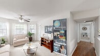 Located at 1521 E Franklin St in Chapel Hill, NC, this 2-bedroom, 2-bathroom residence offers a well-organized single-floor layout designed for comfortable everyday living. The open living room is a bright, welcoming space featuring large bay windows that flood the area with natural light, soft carpet flooring, and a ceiling fan overhead. A private exterior door adds convenient access directly from the living area.

The kitchen is efficiently laid out with white cabinetry, dark countertops, hardwood-style flooring, and a full suite of stainless steel appliances including a refrigerator, electric range, microwave, and dishwasher. A dedicated in-unit laundry closet houses a full-size washer and dryer, adding everyday practicality.

The primary bedroom is a comfortable retreat featuring dual louvered closets, a ceiling fan, and carpeted flooring. The second bedroom offers a closet, natural light from a window, and equally cozy carpeting. Both bathrooms are clean and functional — one features a wide vanity with a large mirror, bright vanity lighting, and a shower/tub combo with hardwood-style flooring, while the second provides a similarly clean, neutral aesthetic. A connecting hallway ties all rooms together efficiently, completing this thoughtfully designed Chapel Hill residence.
