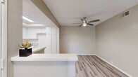 Located in West Covina, CA, this well-appointed 2-bedroom, 2-bathroom single-floor home offers a clean, modern aesthetic throughout. Light wood-style flooring flows seamlessly across the living areas, complemented by neutral wall tones and textured ceilings that create a bright, welcoming ambiance.

The open living room is a standout space, featuring a classic white fireplace, a ceiling fan with integrated lighting, and a sliding glass door that opens to a private patio, inviting natural light and outdoor access. A half-wall peninsula separates the living and dining areas from the well-equipped kitchen, which boasts white cabinetry reaching the ceiling, stone-look countertops, a double basin sink, and stainless steel appliances including a gas range, microwave, and dishwasher. A skylight adds additional brightness to the kitchen.

The spacious primary bedroom includes a large closet with sliding doors, while the second bedroom features vertical blinds and generous proportions. Three closets throughout the home provide ample storage. Both bathrooms are finished with granite-style countertops, white cabinetry, and shower-tub combinations. A connecting hallway ties the layout together efficiently, making this a highly functional and comfortable home.