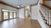 Located at 1223 Alemany St in Morrisville, NC, this well-appointed two-story home offers 3 bedrooms and 3 bathrooms spread across two generously sized floors. The main level features a bright, open-concept living room with warm hardwood-style flooring, crown molding, and a ceiling fan, with French doors leading to a private balcony that fills the space with natural light. The adjacent kitchen is a standout, boasting gray shaker-style cabinetry, granite countertops, stainless steel appliances, a center island with pendant lighting, and direct access to an in-unit laundry room. A dining room completes the main living area. Upstairs, the spacious primary bedroom offers generous square footage and direct access to one of the three full bathrooms. The additional bedrooms are carpeted and well-lit, each featuring closet space. Bathrooms are finished with granite-topped vanities, hardwood-style flooring, and modern fixtures. With seven closets throughout, storage is plentiful. The two-car garage provides direct interior access via a stairway entry. A utility room, hallway, and multiple staircases round out the functional layout of this thoughtfully designed home.