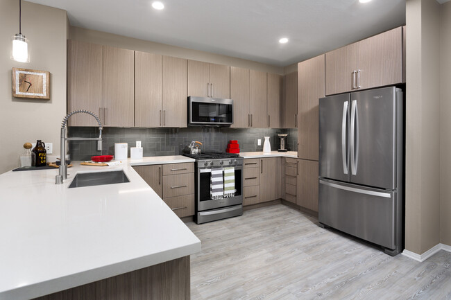 Design Scheme II Kitchen with quartz countertops, stainless steel appliances, and hard surface plank flooring - Avalon Studio City