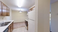Located at 720 County Road B W in Roseville, MN, this one-bedroom, one-bathroom unit offers a practical and comfortable layout across a single floor. The living room is carpeted and generously sized, featuring a baseboard heating system and a wall-mounted air conditioning unit, ensuring year-round comfort. It flows openly toward the dining area and kitchen, which are combined into one functional space. The kitchen is equipped with a white refrigerator, an electric range, wood-toned cabinetry, and tile flooring, with a pendant light fixture above the dining area adding a simple, clean aesthetic. The bedroom is a well-proportioned retreat featuring soft carpeting, a ceiling fan with integrated lighting, a closet with sliding doors, a window offering natural light, and baseboard heating. The bathroom includes a full tub-shower combination with chrome fixtures and classic white tile flooring. Three closets throughout the unit provide ample storage. A hallway connects the main living areas, and a private balcony extends the living space outdoors. The unit's neutral color palette and textured ceilings give it a straightforward, move-in-ready character well-suited for comfortable everyday living.