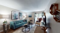 Located at 3050 Kirklevington Dr in Lexington, Kentucky, this single-floor residence offers a thoughtfully designed layout that balances comfort and style throughout. The living room serves as a welcoming centerpiece, featuring neutral-toned walls, plush carpeting, and a large sliding glass door that invites abundant natural light and views of the surrounding greenery. The space is highlighted by contemporary artwork, elegant wingback chairs, and a tufted sofa that together create a refined yet relaxed atmosphere. Adjacent to the living area, the dining space features rich hardwood flooring, a ceiling fan with light fixture, and an open pass-through that connects visually to the rest of the home, enhancing its open feel. The kitchen is well-equipped with warm cherry wood cabinetry, granite-style countertops, hardwood floors, and black appliances including a refrigerator, range, and built-in microwave. The bedroom is a serene retreat with soft carpeting, neutral walls, and warm ambient lighting, complemented by decorative wall accents that add a personalized touch. The bathroom includes a full tiled tub-shower combination, offering a clean and functional design. Overall, this residence presents a cohesive and inviting living environment in a desirable Lexington location.