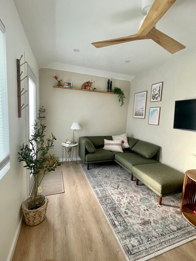 Cozy living room space. TV is smart and comes out from the wall. High ceilings throughout! - 4661 Berwick Dr