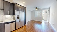Located in the desirable Carmel Valley neighborhood of San Diego, this single-floor residence offers a clean, modern aesthetic with thoughtfully selected finishes throughout. The open-concept kitchen is a standout feature, showcasing dark wood cabinetry, bright white quartz countertops, a classic subway tile backsplash, and a full suite of stainless steel appliances including a gas range, built-in microwave, dishwasher, and a side-by-side refrigerator with ice and water dispenser. The kitchen flows naturally into the living area, which is finished with warm hardwood-style flooring and a ceiling fan, creating a comfortable and airy atmosphere. A sliding door opens to a private balcony, allowing natural light to fill the space. Bedrooms are carpeted for comfort, each featuring windows with horizontal blinds that frame views of the surrounding community. One bedroom includes a generous walk-in closet with double hanging rods and built-in shelving for ample storage. The bathroom is finished with neutral tile flooring, a dark wood floating vanity, quartz countertop, and framed mirrors, reflecting a clean and contemporary design sensibility throughout this well-appointed San Diego home.