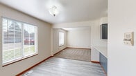 Located at 3079 E Springview Dr in Holland, MI, this 2-bedroom, 1-bathroom unit offers a well-designed single-floor layout with a thoughtful mix of modern updates and comfortable living spaces. The kitchen is a standout feature, boasting gray shaker-style cabinetry, white subway tile backsplash, light countertops, and a full suite of stainless steel appliances including a gas range, built-in microwave, dishwasher, and refrigerator. Light wood-look flooring flows through the kitchen and entry areas, giving the space a clean, contemporary feel. The kitchen opens toward the living area via a peninsula with a sink, creating a connected, functional layout. The two bedrooms are carpeted and filled with natural light — the primary bedroom includes a wood-paneled closet and warm-toned trim, while the second bedroom features a window with outdoor views. A sliding glass door in the living area provides direct access to the outdoors. The bathroom is generously sized, featuring a long dual-sink vanity with navy blue cabinetry, gold hardware, white countertops, and matching light wood-look flooring. A dedicated closet adds practical storage to round out this well-appointed home.