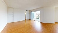 Located on Chenault Street in the sought-after Brentwood neighborhood of Los Angeles, this 2-bedroom, 2-bathroom residence offers a bright and functional single-floor layout. Light wood flooring flows throughout the space, complementing the clean white walls and creating a cohesive, airy atmosphere.

The living room serves as the heart of the home, featuring a textured ceiling, sliding glass doors that open to a private balcony, and abundant natural light. Adjacent to the living area, the galley-style kitchen is outfitted with white cabinetry, a marble-style countertop, open shelving, and stainless steel appliances, with a window above the sink providing additional light. A built-in cabinet nook adds extra storage and counter space.

The spacious primary bedroom is generously sized, offering a wide window with neighborhood views and two mirrored sliding-door closets with built-in shelving. The second bedroom is well-proportioned and bright, also featuring a large window with an outdoor view. Both bathrooms are finished with warm wood vanities, granite countertops, framed mirrors, and light wood flooring, with one bath offering a full tub-shower combination.

A hallway connects the rooms efficiently, completing this well-organized and light-filled residence.