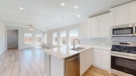 Located at 1421 Twin Forks Drive in the Maplewood community of Saginaw, TX, this single-story, 3-bedroom, 2-bathroom home offers a bright and modern living experience. The open-concept kitchen and living area is the heart of the home, featuring white shaker cabinetry, a subway tile backsplash, stainless steel appliances including a gas range, built-in microwave, and refrigerator, as well as a large center island with a double sink. Light wood-look flooring flows throughout the main areas, complemented by recessed lighting and a ceiling fan. Multiple windows across the rear wall flood the living space with natural light and offer views of the expansive backyard. The three bedrooms are finished with plush carpet and feature dedicated closets, including a walk-in closet in the primary suite. The bathrooms are appointed with marble-style tile, and one includes a tub/shower combo with full tile surround. A dedicated laundry room with shelving provides added convenience. Four hallways and four closets ensure ample storage throughout. The property also includes a generously sized, fenced backyard, offering plenty of outdoor space.