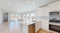 Located at 1421 Twin Forks Drive in the Maplewood community of Saginaw, TX, this single-story, 3-bedroom, 2-bathroom home offers a bright and modern living experience. The open-concept kitchen and living area is the heart of the home, featuring white shaker cabinetry, a subway tile backsplash, stainless steel appliances including a gas range, built-in microwave, and refrigerator, as well as a large center island with a double sink. Light wood-look flooring flows throughout the main areas, complemented by recessed lighting and a ceiling fan. Multiple windows across the rear wall flood the living space with natural light and offer views of the expansive backyard. The three bedrooms are finished with plush carpet and feature dedicated closets, including a walk-in closet in the primary suite. The bathrooms are appointed with marble-style tile, and one includes a tub/shower combo with full tile surround. A dedicated laundry room with shelving provides added convenience. Four hallways and four closets ensure ample storage throughout. The property also includes a generously sized, fenced backyard, offering plenty of outdoor space.