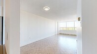 Located on the 9th floor at 5600 Sheppard Avenue East in Toronto's Scarborough district, this well-laid-out two-bedroom, two-bathroom unit offers a comfortable and functional living environment. The space is unified throughout by classic parquet flooring in a warm, light wood tone, lending a timeless character to every room.

The living area is a standout, featuring expansive floor-to-ceiling windows that flood the space with natural light and frame open views of the surrounding treetops and neighbourhood skyline. Access to a balcony further extends the living space outdoors. The kitchen is positioned conveniently adjacent to the living area and is equipped with stainless steel appliances.

Both bedrooms are well-proportioned, each featuring sliding-door closets and the same warm parquet flooring. The primary bedroom offers a generous footprint, while the second bedroom provides comfortable accommodations for guests or a home office.

The two bathrooms are clean and functional in design. One features a full bathtub with classic white subway tile surround and chrome fixtures, while the second offers a modern vanity with stone-look countertop, dark wood cabinetry, and chrome hardware. Textured ceilings are consistent throughout the unit, adding a subtle architectural detail to the overall aesthetic.