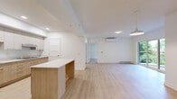 Located at 3250 Boulevard Henri-Bourassa Est in Montréal, this well-appointed 2-bedroom, 1-bathroom unit offers a bright, modern living experience across a generous single floor. Light wood laminate flooring runs throughout, complementing the clean, neutral palette of white walls and trim that define the overall aesthetic.

The open-concept kitchen is a standout feature, showcasing two-tone cabinetry in natural wood and white, white quartz countertops, stainless steel appliances including a built-in oven and refrigerator, and a central island that provides additional workspace and visual definition between the kitchen and living areas. Recessed lighting enhances the bright, contemporary feel.

The living area is bathed in natural light through large sliding glass doors that open onto a private balcony overlooking lush, mature greenery — a tranquil outdoor view that adds a sense of calm to the space. A wall-mounted mini-split air conditioning unit ensures year-round comfort, complemented by baseboard heating.

The spacious primary bedroom features a large window framing garden views, light flooring, and a built-in closet. The second bedroom also includes closet storage and light-filled interiors. The bathroom is finished in crisp white tile and features a soaker tub with a shower and accessibility grab bars. A dedicated closet provides additional storage throughout the unit.