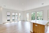 Located at 37 Orange Road in Montclair, NJ, this thoughtfully designed 2-bedroom, 2-bathroom residence offers a bright and contemporary living experience on a single floor. Light hardwood-style flooring runs throughout, complementing the clean white walls and recessed lighting that give the space a fresh, modern aesthetic.

The open-concept living room is a standout feature, bathed in natural light streaming through a wall of French doors that open to a balcony with outdoor views—ideal for entertaining or relaxing. Adjacent to it, the kitchen is well-appointed with warm wood cabinetry, white quartz countertops, stainless steel appliances including a gas range, microwave, and refrigerator, and a sleek tile backsplash that adds texture and style.

The spacious primary bedroom features large windows overlooking lush tree canopy views, providing a tranquil retreat. It includes a generous walk-in closet with dual hanging rods. The en-suite bathroom boasts a double-sink vanity with warm wood cabinetry, white quartz counters, and a large mirror with modern sconce lighting. The second bathroom mirrors the same refined finishes with a single-sink vanity. The second bedroom is bright and versatile, well-suited as a guest room or home office.