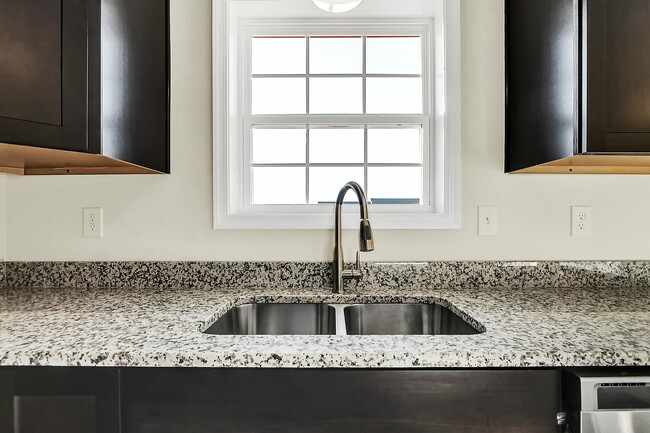 Experience elegance with this modern kitchen design, featuring sleek finishes and natural light. - Hidden Meadows