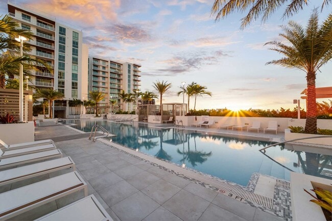 Sunset on The Bridge at Quantum Apartments palm lined pool deck. - Quantum Apartments