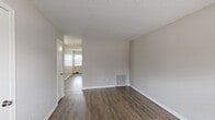 Located at 5581 Burnlee Pl in Raleigh, NC, this single-floor, two-bedroom, one-bathroom home offers a practical and comfortable layout. The living area features warm hardwood-style flooring, neutral gray walls, and a textured ceiling, creating a clean and inviting atmosphere. Natural light flows in through blinds-fitted windows, adding brightness throughout.

The kitchen is well-equipped with white cabinetry, granite-style countertops, a stainless steel dishwasher, a black electric range, and a black refrigerator — offering ample storage and functionality for everyday cooking.

Both bedrooms are carpeted for comfort and feature ceiling fans with light fixtures and multiple windows that bring in natural light. The primary bedroom is generously sized and includes a dedicated closet, while the second bedroom also benefits from its own closet and ceiling fan. A connecting hallway ties the rooms together efficiently.

The full bathroom features a vanity with a speckled countertop, an integrated sink, white cabinetry, and a well-lit mirror. The overall design throughout the home is clean, neutral, and move-in ready, making it an ideal space in the heart of Raleigh.