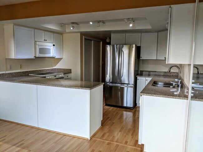 Kitchen with granite countertops and modern appliances. - 11640 100th Ave NE