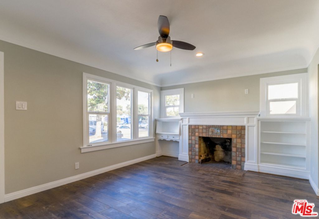 Living area features Built-in shelving, a large walk-in storage closet and a decorative Batchelder fireplace! - 1814 Browning Blvd