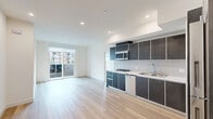 Located at 951 Ogden Ave in the heart of Los Angeles, this modern 1-bedroom, 1-bathroom unit offers a thoughtfully designed layout with clean, contemporary finishes throughout. Light wood-tone flooring runs continuously through the space, complementing the bright white walls and recessed lighting that create an airy, open ambiance.

The open-concept kitchen and living area form the heart of the unit. The kitchen is outfitted with sleek dark cabinetry, white quartz countertops, a tile backsplash, and a full suite of stainless steel appliances including a gas cooktop, dishwasher, microwave, and refrigerator. A stacked in-unit washer and dryer is conveniently tucked within the kitchen area. The living space flows naturally toward a sliding glass door that opens to a private balcony, offering open views of the Los Angeles cityscape.

The bedroom is a well-proportioned, tranquil retreat featuring its own sliding glass door to a second balcony access point and a mirrored closet. The bathroom is finished in crisp white tile with a chevron-patterned tub surround, a sliding glass shower door, and wood-tone flooring that ties the space together cohesively. Recessed lighting throughout and abundant natural light from multiple sliding glass doors enhance the modern, polished character of this Los Angeles residence.