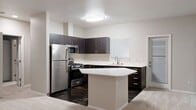 This contemporary townhouse in Issaquah, WA offers 950 square feet of efficiently designed living space across two floors. The main level boasts an open-concept layout, combining the kitchen and living areas. The kitchen features dark wood cabinetry, stainless steel appliances, and a practical island, perfect for casual dining or food preparation. The living room is highlighted by a cozy fireplace, creating a warm ambiance.

The spacious 160 square foot primary bedroom occupies the upper level, providing a private retreat. The home includes one full bathroom and two closets for ample storage. In-unit laundry facilities add convenience to daily life. Throughout the home, neutral tones and carpeting create a blank canvas for personalization.

Large windows with blinds allow for natural light control, while the balcony offers outdoor space and views of the surrounding greenery. The property's location at 22500 SE 56th St in Issaquah provides a balance of suburban tranquility and accessibility to urban amenities. With its modern features and thoughtful design, this townhouse presents an ideal living solution for those seeking comfort and style in a compact space.