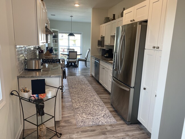 Kitchen leading into dining area and balcony - 410 N Saint Joseph St