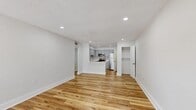 Located at 2300 Roy Hanna Dr S in Saint Petersburg, FL, this well-appointed one-bedroom, one-bathroom unit offers a thoughtfully designed single-floor layout with modern finishes throughout. Warm hardwood-style flooring flows seamlessly across every room, creating a cohesive and inviting atmosphere.

The open living area is bright and airy, with recessed lighting and a large window that fills the space with natural light and provides views of the surrounding greenery. The layout transitions smoothly into the kitchen, which features gray shaker-style cabinetry, crisp white countertops, a stainless steel sink, and a full suite of stainless steel appliances including a refrigerator, electric range, and built-in microwave.

The generously sized bedroom offers comfortable proportions, a ceiling fan with light fixture, and a window with garden views, creating a calm, restful retreat. A dedicated utility room houses a stacked washer and dryer, adding everyday convenience. The hallway connects the rooms efficiently, with a closet providing additional storage.

The bathroom is clean and functional, featuring a tiled shower-tub combination, a vanity with ample counter space, and consistent flooring that ties the design together. Recessed lighting throughout enhances the bright, modern feel of the entire unit.