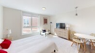 This well-designed 340 square foot apartment in Quincy, MA, offers a perfect blend of comfort and functionality. The space features a single bedroom spanning 190 square feet, providing ample room for rest and relaxation. The bedroom boasts large windows that flood the area with natural light, complemented by a neutral color palette and modern furnishings.

The living area seamlessly integrates with the bedroom, showcasing a smart layout that maximizes the available space. Wood-look flooring runs throughout, adding warmth and continuity. The kitchen, though compact, is equipped with contemporary stainless steel appliances, dark wood cabinetry, and a sleek countertop, offering everything needed for meal preparation.

The bathroom is thoughtfully designed with a large vanity, illuminated mirror, and a spacious shower enclosure. Its clean lines and neutral tones create a spa-like atmosphere. Despite its modest size, the apartment doesn't compromise on storage, with built-in closets and clever space-saving solutions evident throughout.

Located at 1500 Hancock St, this apartment combines urban convenience with a cozy, efficient living space. Its well-planned layout and modern amenities make it an ideal choice for those seeking a comfortable city dwelling in a prime location.