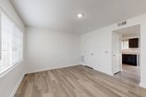 Located at 308 Scott St SW in Atlanta, GA, this two-story, three-bedroom, two-bathroom home offers a well-organized layout spread across two floors. The main level houses a combined dining room and kitchen, a living room, and a patio that overlooks a landscaped yard with mature trees and neighborhood views. The kitchen is outfitted with dark espresso cabinetry, light granite-style countertops, black appliances, and wood-look flooring that carries throughout the home. The upper floor contains the three bedrooms, including a spacious primary bedroom with generous closet storage featuring built-in wire shelving. Additional bedrooms each include closet space and are finished with the same clean, neutral palette of white walls and wood-look plank flooring. Both bathrooms feature granite-style vanity countertops with undermount sinks, dark cabinetry, and a tiled tub-shower combo with chrome fixtures. The home also includes a dedicated laundry area, a utility room, multiple hallways, and a total of five closets providing exceptional storage. The bright, clean interior, consistent modern finishes, and functional multi-level floor plan make this Atlanta home a practical and comfortable residence.