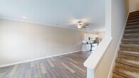 Located at 1818 Ferndale Ct in Chattanooga, Tennessee, this two-story home offers a well-designed layout across both levels. The main floor welcomes you with a bright, open-concept living area featuring hardwood-style flooring, crown molding, recessed lighting, and a ceiling fan. A large front-facing window fills the space with natural light, while a staircase with a clean white banister connects both floors seamlessly.

The kitchen is a functional highlight of the main level, equipped with white cabinetry, granite countertops, a subway tile backsplash, stainless steel appliances, and a central island with a deep single-basin sink and pendant lighting overhead. French doors lead from the kitchen to a rear outdoor area, providing easy access and additional natural light.

Upstairs, the bedrooms are carpeted for comfort and include ceiling fans and ample closet space. The primary bedroom features a dedicated walk-in closet and direct access to a private bathroom. Additional bedrooms are well-proportioned, each with generous closet storage.

The bathrooms are consistently appointed with white cabinetry, granite countertops, and full tub-shower combinations, maintaining a cohesive and clean aesthetic throughout the home. The overall design is neutral and move-in ready, offering a practical and comfortable living environment.