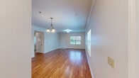 Located at 1555 Lake Ave in Metairie, Louisiana, this well-appointed two-bedroom, two-bathroom single-story home offers a comfortable and functional layout. The open-concept kitchen and living area serves as the heart of the home, featuring rich cherry wood cabinetry, granite countertops, stainless steel appliances including a range, microwave, dishwasher, and refrigerator, along with warm hardwood flooring and crown molding throughout. Natural light filters in through multiple windows, creating a bright and welcoming atmosphere. The living area flows seamlessly from the kitchen, accented by a chandelier and clean, neutral-toned walls. The primary bedroom is a generous retreat with plush carpet, a ceiling fan, a double-door closet, and direct access to an en-suite bathroom featuring a granite vanity and a tub-shower combination. The second bedroom also offers carpet flooring, a ceiling fan, and a window with natural light. A second full bathroom mirrors the same clean aesthetic with a white vanity, granite countertop, and tiled flooring. A connecting hallway ties the rooms together efficiently. Throughout the home, consistent finishes and neutral tones create a cohesive, move-in-ready feel.