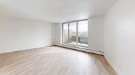 This well-appointed two-bedroom, two-bathroom unit at 10 Highland Crescent in Kitchener, Ontario offers a thoughtfully designed layout across a single floor. Light hardwood-style flooring runs throughout the space, complementing the bright, neutral palette of white walls and textured ceilings.

The kitchen is a standout feature, offering ample cabinetry with white shaker-style cabinets, dark countertops, subway tile backsplash, and stainless steel appliances including a range, microwave, refrigerator, and dishwasher. It flows conveniently toward the dining area and hallway.

The spacious living room is bathed in natural light through large floor-to-ceiling sliding glass doors that open directly onto a private balcony. The balcony overlooks a green park and provides open views of the Kitchener cityscape.

Both bedrooms are generously sized, with the primary bedroom featuring a large sliding-door closet and a bright window with outdoor views. Five closets throughout the unit provide excellent storage. The two bathrooms include a full tub-shower combination finished with classic white subway tile. The unit also features a dedicated entrance and hallway, enhancing privacy and functionality within the overall layout.