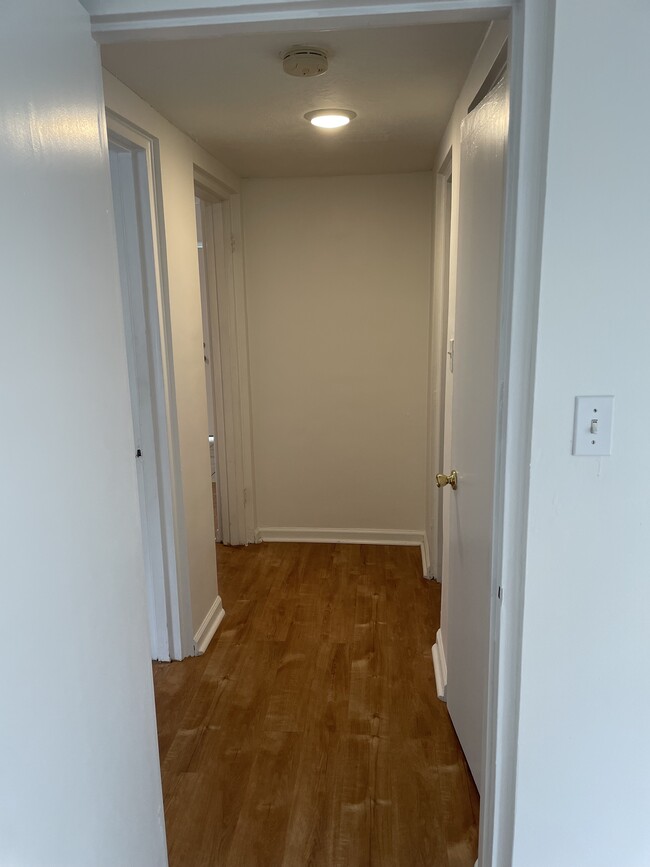 Hallway provides bedroom privacy and features linen closet - 2000 Central Ave