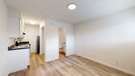 This 220 square foot studio apartment in Oklahoma City offers a thoughtfully designed living space. The open-concept layout maximizes the available area, creating a sense of spaciousness despite its compact size. The room features light-colored walls and wood-look flooring, enhancing the bright and airy atmosphere.

The kitchen, though small, is efficiently designed with white cabinetry, stainless steel appliances, and a dark countertop, providing a modern contrast. It includes a gas stove, refrigerator, and ample storage space. The bathroom is clean and functional, featuring a shower/tub combination, toilet, and simple fixtures.

A window with horizontal blinds allows natural light to filter in, while a wall-mounted air conditioning unit provides climate control. The open area can accommodate a bed and living space, making it suitable for single occupancy or as a pied-à-terre.

The property's location at 1200 S Meridian Ave places it conveniently within Oklahoma City, offering urban living in a condensed format. This studio apartment is an excellent example of efficient space utilization, ideal for those seeking a minimalist lifestyle or a low-maintenance city dwelling.