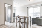 Located at 275 Larch St in Waterloo, Ontario, this efficiently designed two-bedroom, two-bathroom unit offers a thoughtfully laid-out single-floor plan with a clean, contemporary aesthetic throughout. Light-toned vinyl plank flooring runs continuously across the space, lending a cohesive and modern feel to every room.

The kitchen is a functional highlight, featuring dark wood-tone cabinetry with sleek hardware, granite-look countertops, a white subway tile backsplash, and stainless steel appliances including a refrigerator, electric range, and dishwasher. A stacked washer and dryer unit is conveniently tucked into an enclosed laundry closet directly adjacent to the kitchen.

The open living area benefits from a large sliding glass door that brings in natural light and provides outdoor access. A connecting hallway leads to both bedrooms and bathrooms, maintaining a clear and practical flow. The primary bedroom features a window with exterior views, while the second bedroom is a compact, well-defined space. Both rooms carry the same neutral, light-filled palette.

The two bathrooms are finished with dark vanity cabinetry, granite-look countertops, and bright vanity lighting. One bathroom includes a full soaker tub with built-in shelving. The overall design is modern and understated, making efficient use of every square foot.