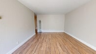 Located at 1355 Mt Pisgah Rd in Walnut Creek, California, Unit #9 is a single-floor residence finished with a clean, neutral palette throughout. The spacious living area features warm wood-look flooring, crisp white baseboards, and a wall-mounted heating unit, creating a bright and welcoming atmosphere. A sliding glass door floods the room with natural light and provides direct access to an outdoor area, enhancing the sense of openness. The galley-style kitchen is well-appointed with white shaker cabinetry, white quartz countertops, and a full suite of stainless steel appliances including a refrigerator, electric range, built-in microwave, and dishwasher. A pendant light hangs above the adjacent dining area, which benefits from a large window that invites abundant natural light. The bedrooms are carpeted for comfort and finished in soft, neutral tones, each offering a quiet and restful environment. Sliding closet doors and windows with blinds are featured in the bedroom spaces, providing both storage and privacy. The overall design is cohesive and modern, with consistent neutral tones, updated finishes, and thoughtful details throughout, making this a well-maintained and move-in ready home in the heart of Walnut Creek.