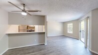 Located at 681 N Saginaw Blvd in Saginaw, TX, this single-floor residence offers a practical and modern layout across a compact, efficiently designed footprint. The open-concept main area seamlessly integrates the living room, dining space, and kitchen, creating a versatile and connected environment. The kitchen features white cabinetry with brushed nickel hardware, white countertops, a stainless steel sink, and stainless steel appliances including a refrigerator and range. A pass-through counter adds to the open feel. Throughout the home, wood-look vinyl plank flooring provides a cohesive, low-maintenance aesthetic. The living room is bright and airy, benefiting from a large window and a sliding glass door that opens to a private balcony with outdoor views — a notable feature that brings natural light deep into the space. A ceiling fan is installed in the living area. The bedroom is a comfortable, well-proportioned space with its own ceiling fan, a sizable window with blinds offering natural light and outdoor views, and direct access to a dedicated closet. The bathroom is clean and functional, featuring a tub-shower combo with white tile surround, a white vanity with stone-look countertop, and a built-in linen cabinet for added storage. A textured ceiling is consistent throughout the home.