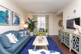 This four-story residence in Decatur, Georgia offers a thoughtfully designed layout spread across multiple levels, connected by a staircase visible through the home's open vertical core. Warm hardwood flooring flows through the main living areas, including a dining space framed by crown molding, a pendant light fixture, and French doors that invite natural light. The adjacent living area provides a comfortable gathering space with neutral walls well-suited for artwork and décor.

The kitchen features granite countertops, light wood cabinetry, and stainless steel appliances, opening conveniently toward the main corridor. Bedrooms are carpeted and generously sized, with large windows allowing ample natural light. One bedroom includes a spacious walk-in closet outfitted with wire shelving and hanging rods for organized storage.

Bathrooms are finished with tile flooring and tub-shower combinations. Hallways throughout the home are well-proportioned, with panel doors and clean trim details maintaining a consistent aesthetic. The multi-floor design provides functional separation between living, sleeping, and utility spaces, making this Decatur residence a well-structured and versatile home.